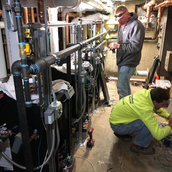 48218162_2110573042524945_4906630772787511296_o two plumbers working on piping