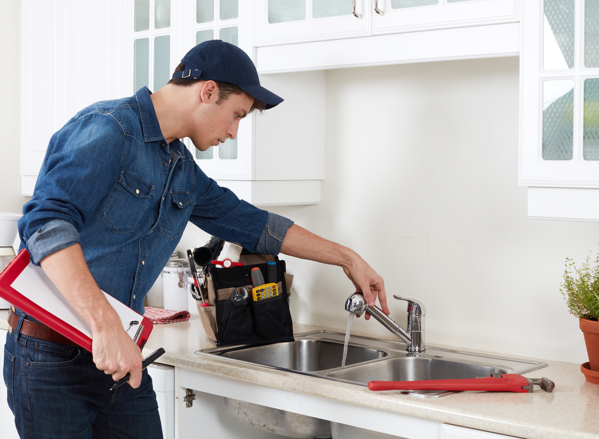 Plumber. plumber checking sink faucet