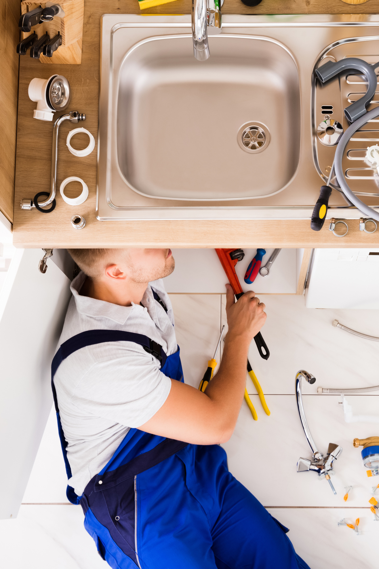 plumber fixing sink drain