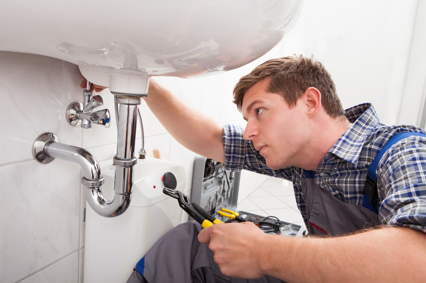 plumber fixing a bathroom sink